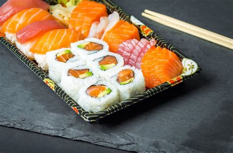 Sushi And Sashimi Rolls On A Black Stone Slatter Fresh Made Sushi Set