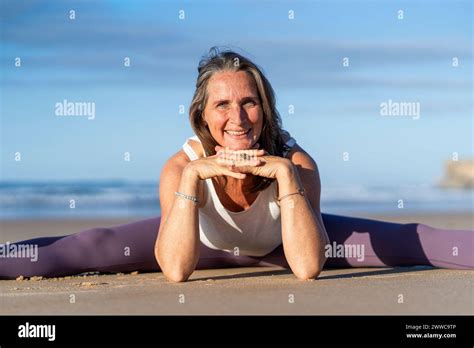 Happy Mature Woman Practicing Yoga At Beach Stock Photo Alamy