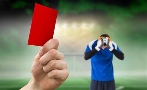 Premium Photo Hand Holding Up Red Card Against Football Pitch Under