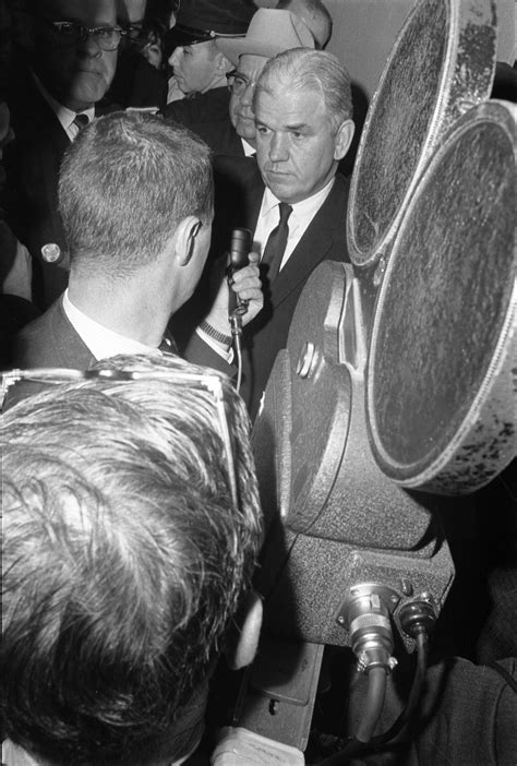 [D.A. Henry Wade and reporters at Dallas Police Department headquarters