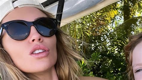 Abbey Clancy Puts On A Busty Display In A Blue Patterned Bikini As She Introduces An Adorable