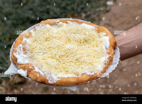 Male Hand Holding A Tasty Langosh A Typical Hungarian Street Food It