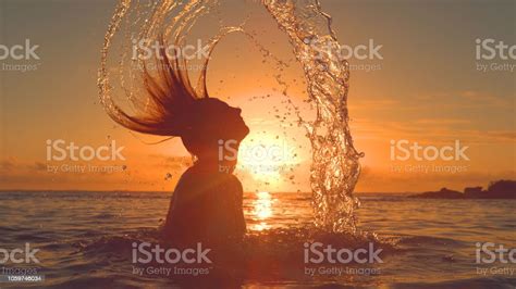 Silhouette Orange Morning Sun Beams Shine On Woman Splashing Water With