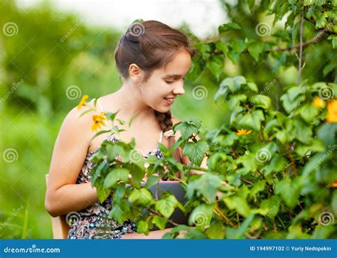 Smiling Farm Young Girl Collecting Berries In Garden Stock Photo