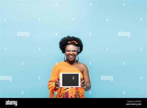 Happy African American Body Positive Woman In Hoop Earrings Holding