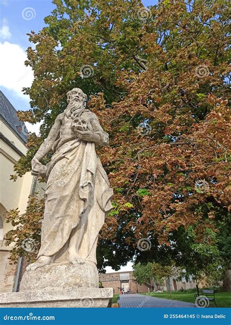 Statue Of An Old Man Holding A Human Skull Trnava Slovakia Stock