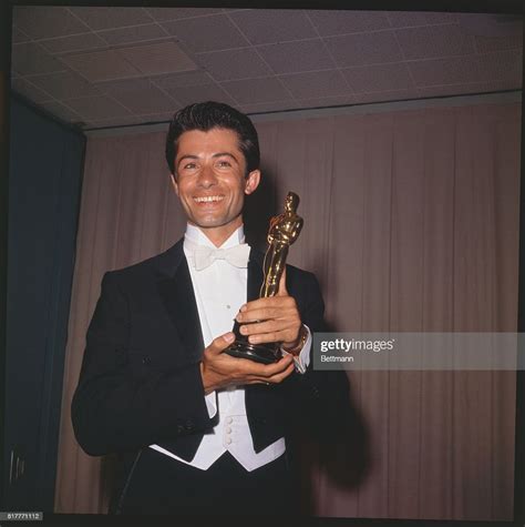 Actor George Chakiris is shown here as he holds his "Oscar." News Photo ...