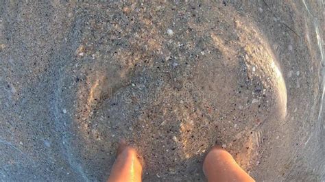 Woman Standing Barefoot On Sand Underwater Digging Feet Into Sand