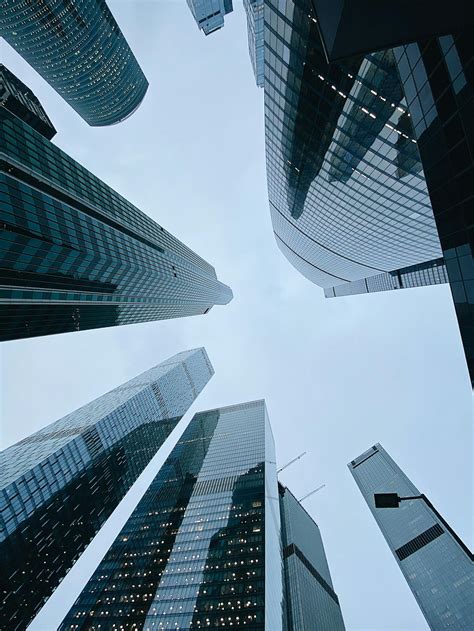 Contemporary skyscrapers with glass facades in downtownFree Stock Photo