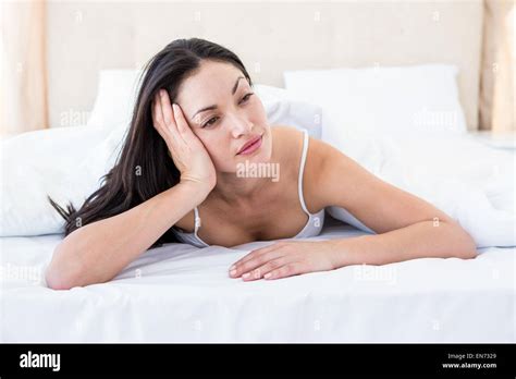 Pretty Brunette Thinking On Bed Stock Photo Alamy