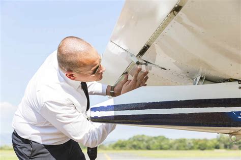 Pilot Doing Pre Flight Inspection On His Sports Plane Stock Photo