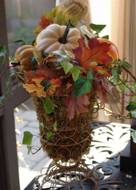 Moss Filled Wire Urns Overflow With Gourds Leaves And Ivy Fall