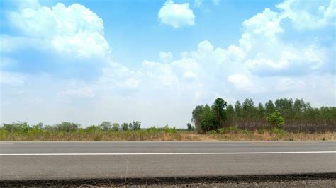 Horizontal view of asphalt road in Thailand. Background Empty land and ...