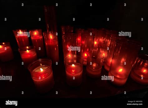 Red Votive Candles In A Church Group Of Warm Glowing Candles On Black Background With Copy