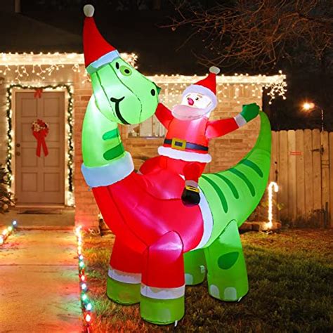 Santa Brings Christmas Cheer By Riding A Giant Dinosaur Inflatable