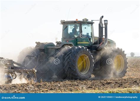 John Deere 9530 Articulated 4WD Tractor Working A Dry And Dusty Field