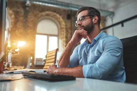 Premium Photo Thinking About Side View Of Young Bearded Man In