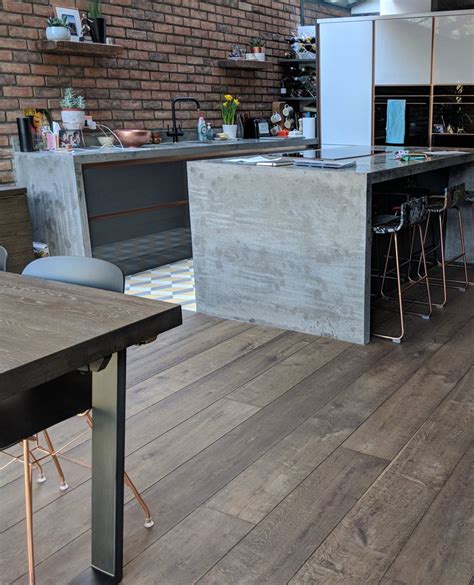 The dark wood flooring in this kitchen defines the dining and living ...