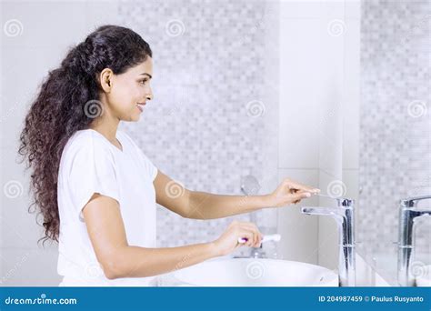 Woman Cleaning Toothbrush After Brushing Her Teeth Stock Image Image