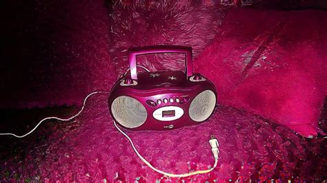 A Purple Radio Sitting On Top Of A Pink Couch