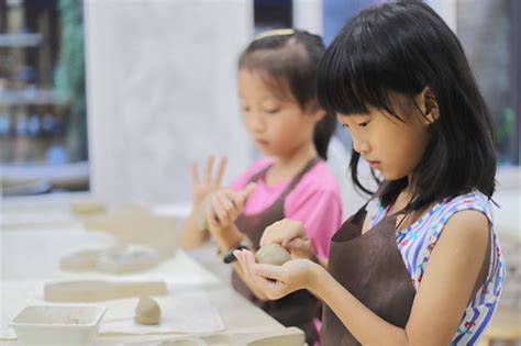 Two Girls Kneading Clay In The Pottery Classroom Stock Photo Download