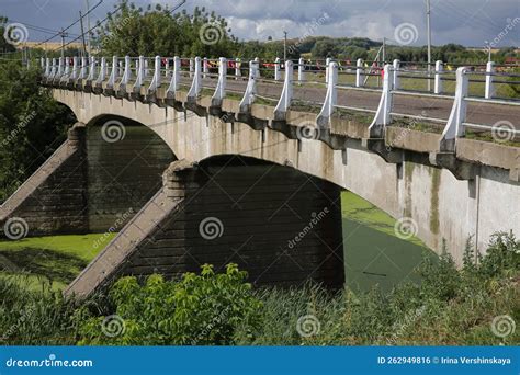 The Old Bridge Over The River With Blooming Green Water The Bridge Was