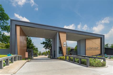 An Entrance To A Building With Two Large Doors On Each Side And Trees