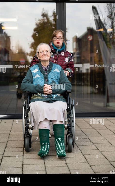 85 Yo Mother In Wheelchair Assisted By Her Down Syndrome Daughter