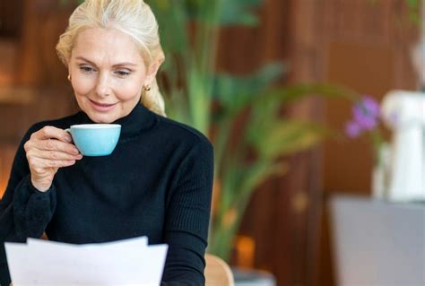 Free Photo Front View Of Older Woman At Work Reading Papers While