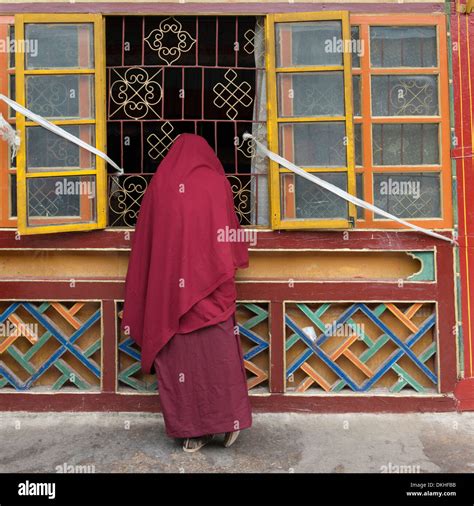 Buddhist Monk Standing At A Window In Drepung Monastery Lhasa Tibet