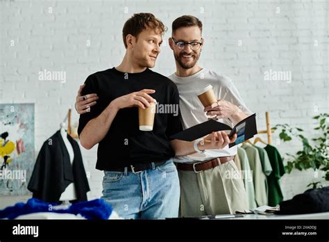 Two Men A Gay Couple Stand Together In A Designer Workshop