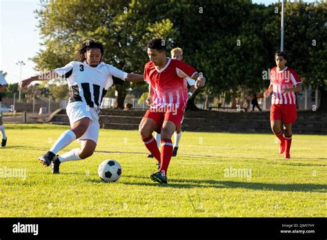 Multiracial Male Players Running And Chasing The Ball During Soccer