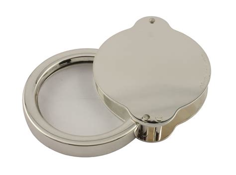 An Open Round Metal Box On A White Background