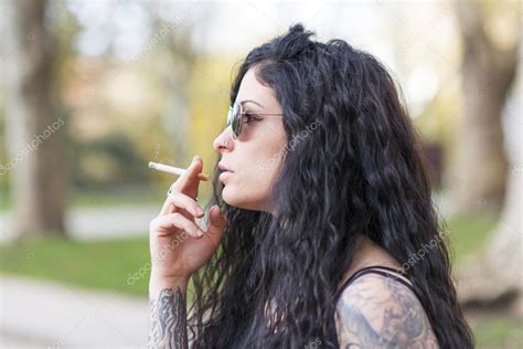 Sensual beautiful tattooed woman smoking. — Stock Photo © leophotos ...