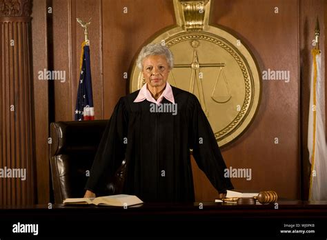 Portrait Of Confident Senior Female Judge Standing In Court Room Stock