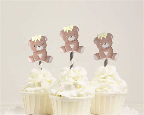 Three Cupcakes With White Frosting And Teddy Bears On Top