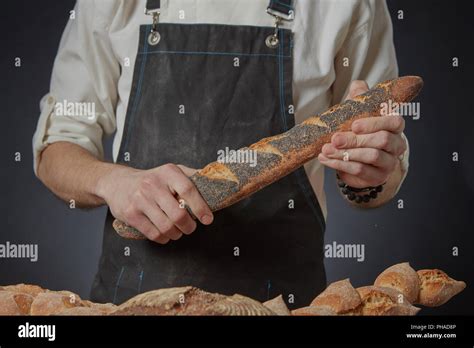 Men's hands hold a baguette Stock Photo - Alamy