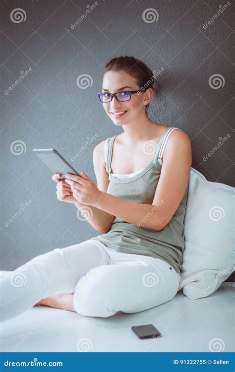 Attractive Caucasian Girl Sitting On Floor With Cup And Tablet Near