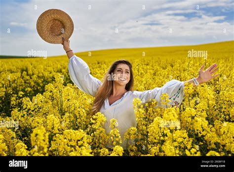 Portrait Of A Beautiful Blonde Hispanic Woman In A Blooming Canola Field Stock Photo Alamy