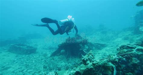 Scuba Diver Exploring Big Ship Wreck Sunk During World War II Off The