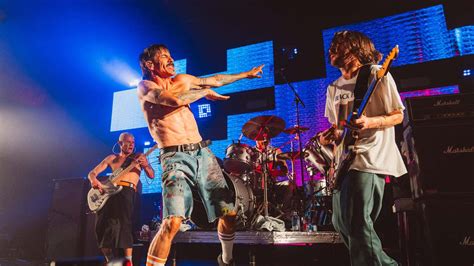 Download The Red Hot Chili Peppers Performing Together On Stage Wallpaper