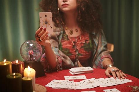 Premium Photo Cropped Image Of Fortune Teller Reading Tarot Card