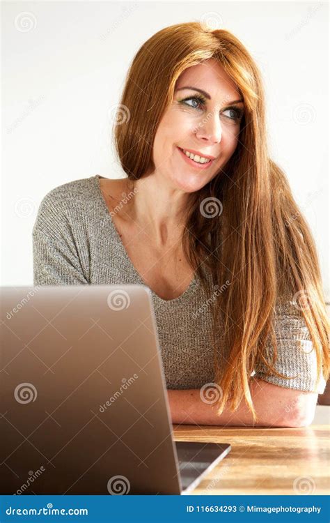 Smiling Mature Woman Sitting At Table With Laptop Stock Image Image