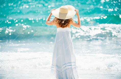 Premium Photo Back View Beautiful Girl With Straw Hat Enjoying