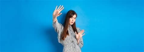 Premium Photo Image Of Young Woman Raising Hands Up Defensive Covering Herself From Camera