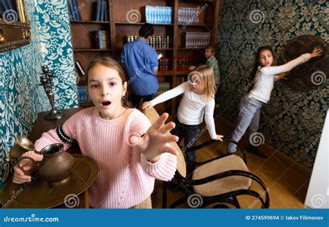 Tween Girl Trying To Reach for Something in Escape Room Stock Photo ...