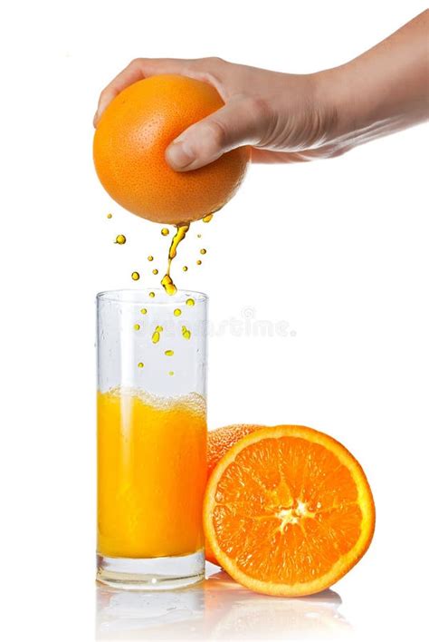 Sliced Of Orange With Splashing Juice On White Background Stock Photo