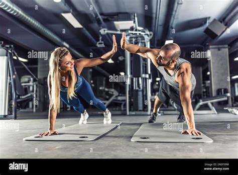 Sport Couple Doing Plank Exercise Workout In Fitness Centrum Man And