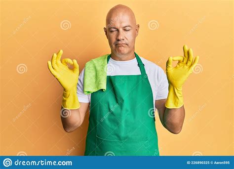 Middle Age Bald Man Wearing Apron Holding Cleaning Gloves Relax And