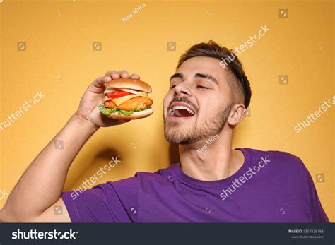 Handsome Man Eating Tasty Burger On Stock Photo 1357836188 Shutterstock